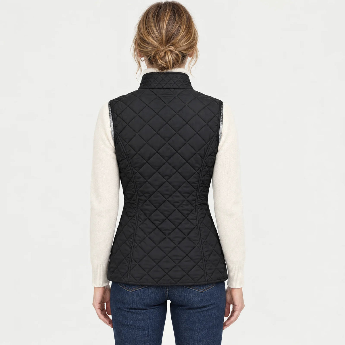 Back view of the black women's heated vest, worn